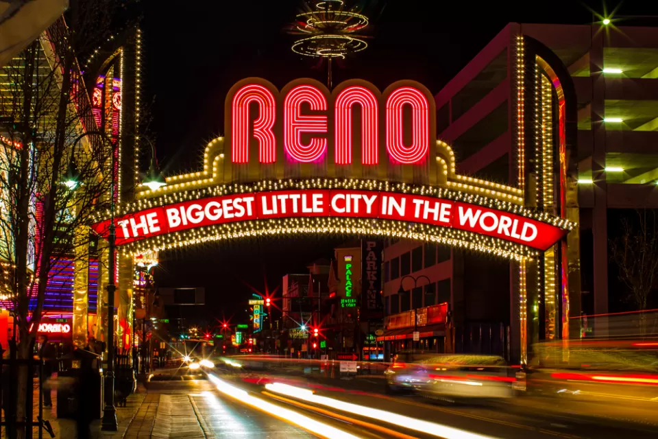 The famous (newer) "Biggest Little City in the World" sign in Reno, Nevada, with blurred lights from passing cars.